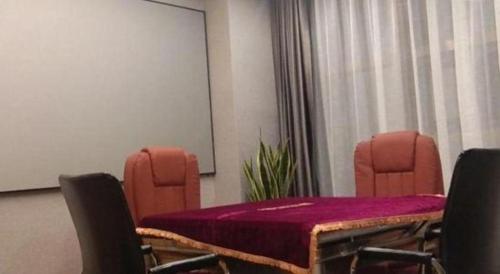 a conference room with a table and chairs with a purple table cloth at Vienna Hotel Zhejiang Lishui Qingtian Post Building in Lishui