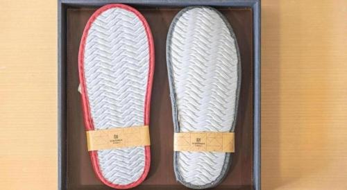 a pair of shoes in a wooden box at Borrman Hotel Jining High-tech Huangtun in Jining