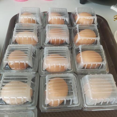 a tray of plastic containers filled with hot dogs at Top Place in Ban Pang Kae
