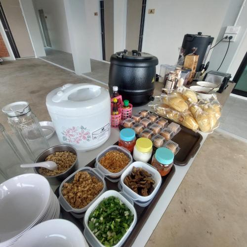 a counter with various dishes of food on it at Top Place in Ban Pang Kae