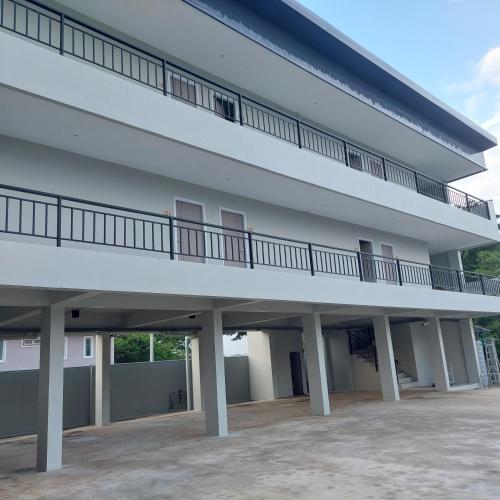 a large white building with a balcony on it at Top Place in Ban Pang Kae