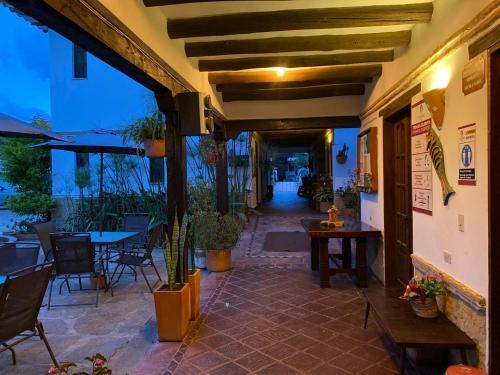 a patio with tables and chairs in a restaurant at Hotel Santa Viviana Villa de Leyva in Villa de Leyva