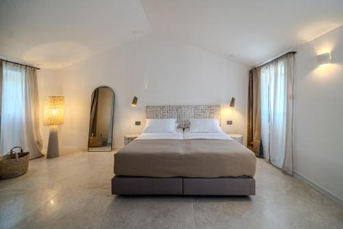 a bedroom with a large bed and a mirror at Villa Kaleta Brac in Sutivan
