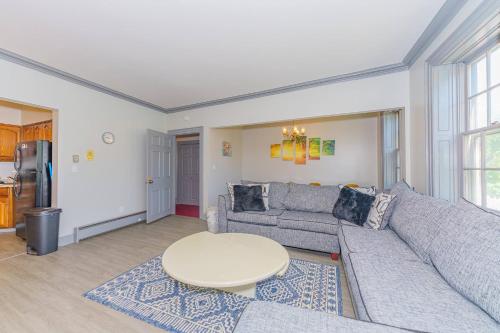 a living room with a couch and a table at Massive 5BD/4BA 3-Story Duplex @ Downtown Albany in Albany
