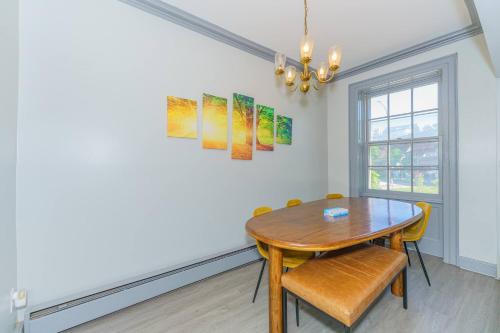 a dining room with a wooden table and chairs at Massive 5BD/4BA 3-Story Duplex @ Downtown Albany in Albany