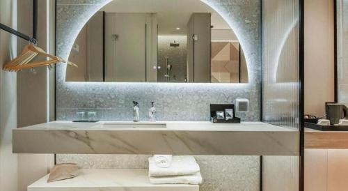 a bathroom with a sink and a mirror at Borrman Hotel Chongqing Bishan Central Street in Chongqing