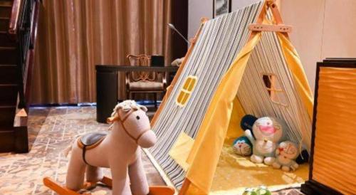 a toy tent with a toy horse and stuffed animals at Royal Tulip Hotel Zhujiajiao Shanghai in Shanghai