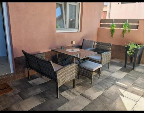 a patio with a table and chairs on a balcony at Apartmani Milat in Sveti Filip i Jakov
