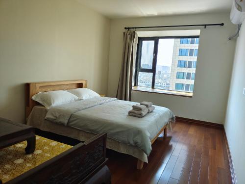 Postel nebo postele na pokoji v ubytování Yuan Apartment