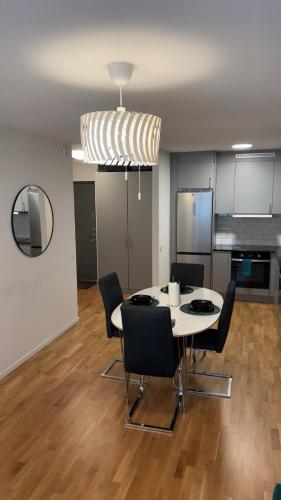 a dining room with a table and chairs at Cozy two rooms appartment in Stockholm