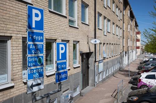 a group of parking signs on the side of a building at Drottninggatans Vandrarhem in Karlskrona