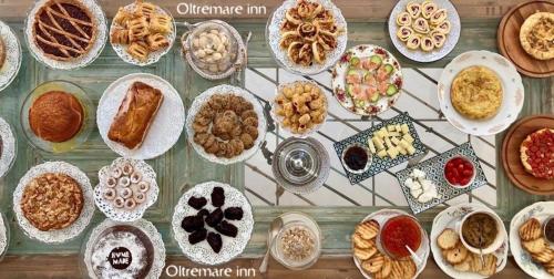 a table topped with lots of different types of food at Oltremare Inn in Spetses