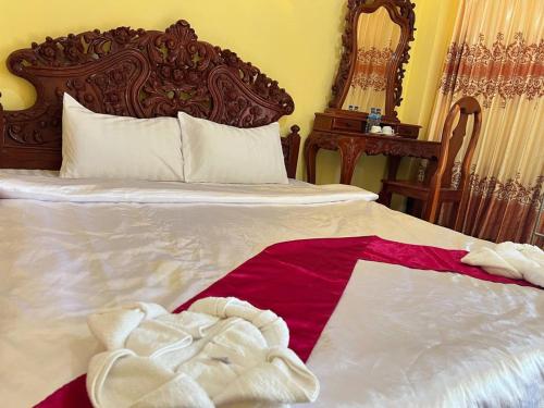 a bedroom with a bed with a towel on it at Lotus Blanc Homestay Villa in Battambang