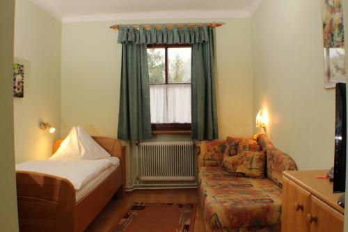a living room with a couch and a window at Gasthof zur Bruthenne in Weissenbach an der Triesting