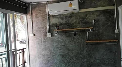 a bathroom with a stone wall with a stove at Hat yao Seaview Beach Room in Trang