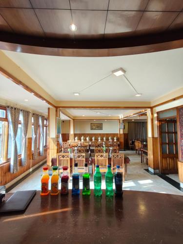 a row of bottles on a table in a room at Hotel Utpala in Gangtok