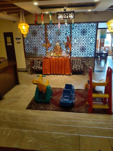 a room with a table and some play equipment at Hotel Utpala in Gangtok