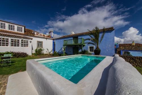 a swimming pool in front of a house at Casa Paço D`Ilhas in Ericeira
