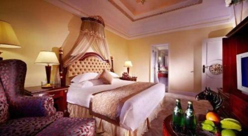 a hotel room with a bed and a chair at New Century Hotel Taizhou 