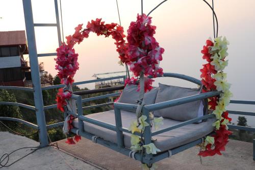 a swing with a wreath and a seat at Suryachaur Nature Retreat in Thāpāgāon