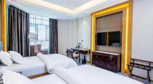 a hotel room with two beds and a large mirror at Metropolo Hotel Yining Development Zone Hanma Building in Kipekyüzi