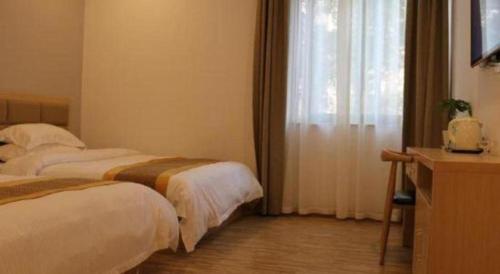 a hotel room with two beds and a window at Shell Shanghai Jiading Nanxiang Town Minzhu Street Hotel in Shanghai