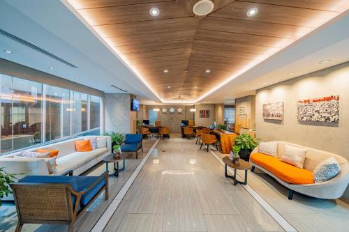 a lobby of a hospital with couches and chairs at Harris Suites Puri Mansion in Jakarta