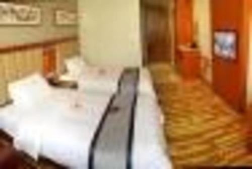 Postel nebo postele na pokoji v ubytování Yitel Tai'an Taishan Hongmen Daimiao