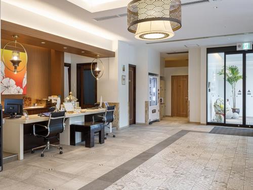 an office with desks and chairs in a room at Kariyushi LCH. Resort in Nago