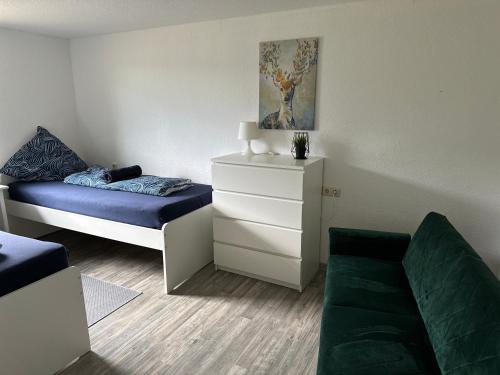 a small room with a bed and a couch at Casa Melina in Bernsdorf