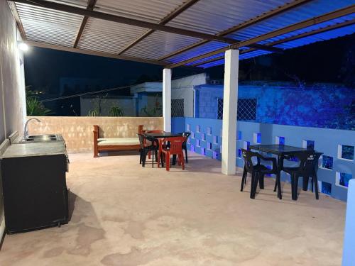 a patio with tables and chairs and a couch at Casa Constanza in Valladolid