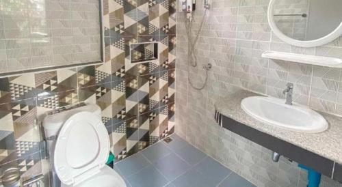 a bathroom with a toilet and a sink at Hihotel Saraburi in Sara Buri