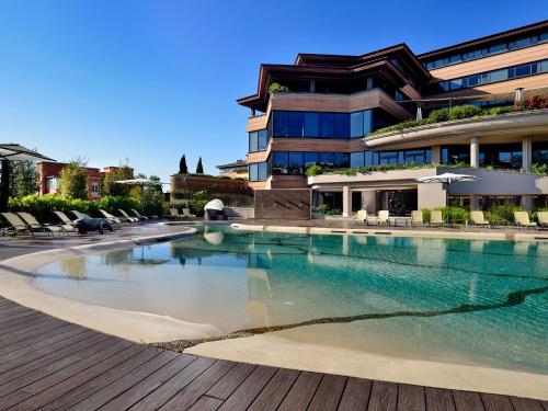 a swimming pool in front of a building at A.Roma Lifestyle Hotel in Rome