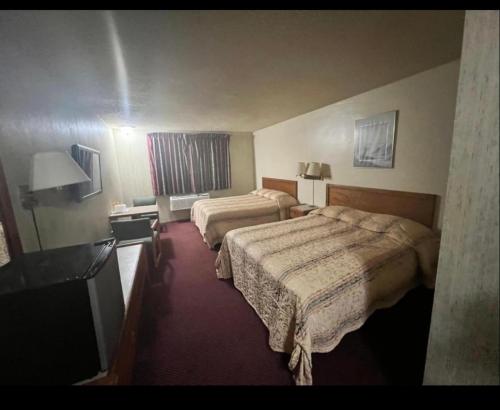a hotel room with two beds and a window at Circle Inn Hotel - Jurupa Valley Riverside 60 Fwy in Riverside