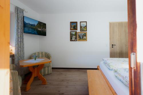 a small room with a bed and a table at Ferienwohnung Mankei in Schönau am Königssee