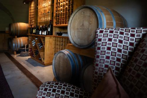 a room with several wine barrels and a chair at umVangati House in Hoedspruit