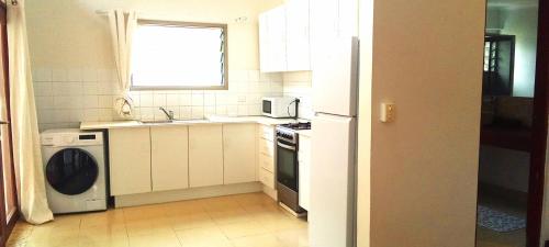 a kitchen with a washer and a sink and a dishwasher at Doomsday Ark Ltd in Port Vila