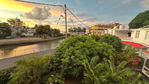 a view of a city with a river and buildings at Pension Ciel d'Eté in Port Mathurin