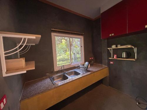 a kitchen with a sink and a window at ลาดวานร รีสอร์ท สมุย Laadwaanorn Resort Samui in Koh Samui