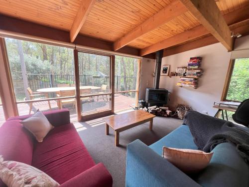 a living room with a couch and a table at Albaski Lodge Room 1 in Mount Buller