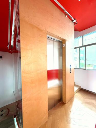 an elevator in an office with a red ceiling at Up Apartment in Jingdezhen