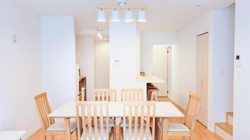 a kitchen and dining room with a table and chairs at Villa Seika -盛夏- in Nago