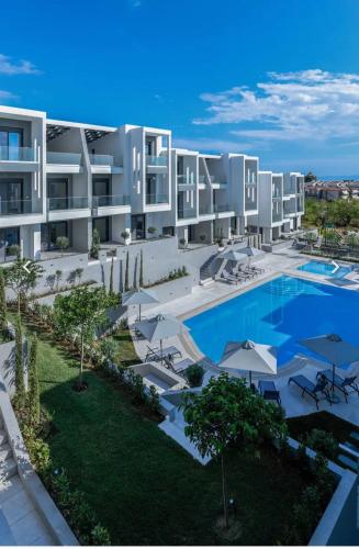 an aerial view of a large apartment building with a swimming pool at Artion Suites Nikiti in Nikiti