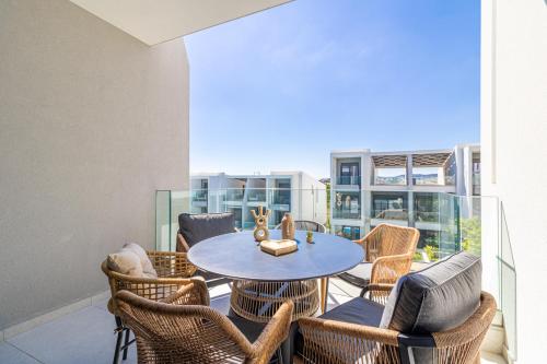 a patio with a table and chairs on a balcony at Artion Suites Nikiti in Nikiti