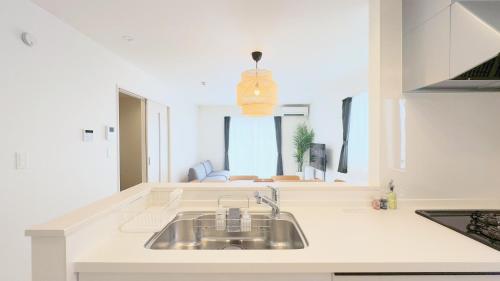 a kitchen with a sink and a counter top at Villa Konatsu -小夏- in Nago