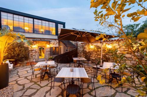 a patio with tables and chairs in front of a building at Zoi Urla in Urla