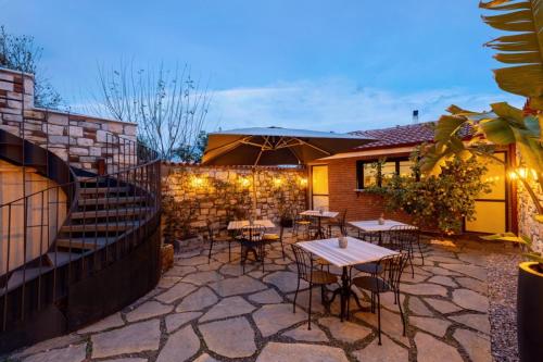 a patio with tables and chairs and a fence at Zoi Urla in Urla