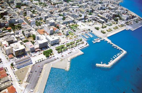 an aerial view of a city with a harbor at Hotel Korinthos in Korinthos