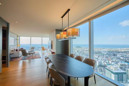 a dining room with a table and chairs at Grand Hyatt Jeju in Jeju