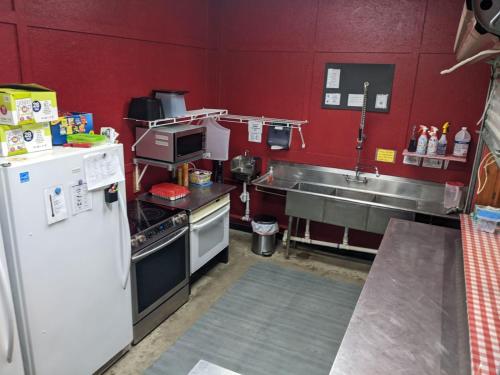 a kitchen with a refrigerator and a sink at Jubilee Ranch in Hempstead